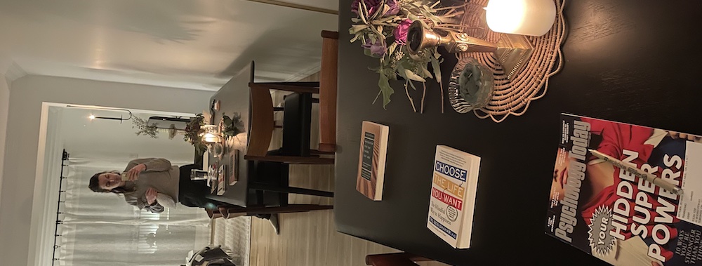 girl taking a photo in a mirror with a psychology today magazine on the dining table